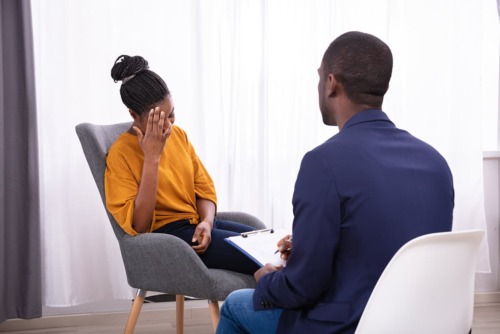 a doctor talking to an upset patient about Galveston drug rehab