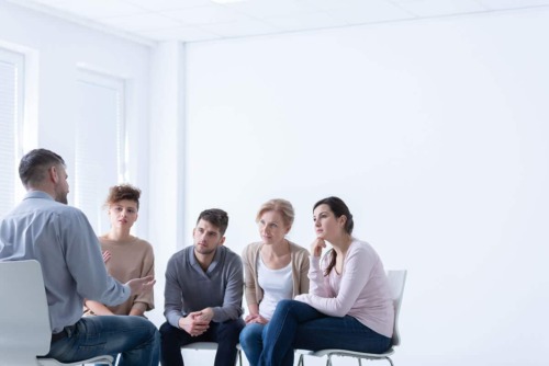 a group therapy session discussing different Houston recovery centers