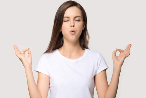 woman meditating because she knows how to practice patience and stress management