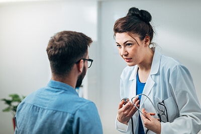 female doctor talking to male patient in a cocaine detox center