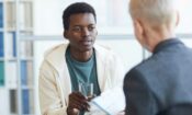 a young man talking to his doctor about coping skills