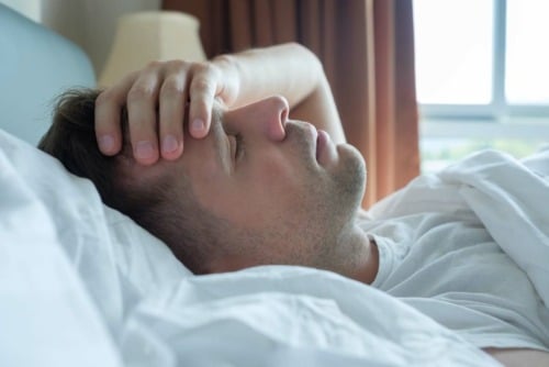 a man feeling sick from experiencing the dangers of binge drinking