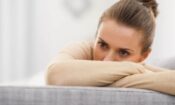 woman with thousand yard stare on couch needs depression treatment