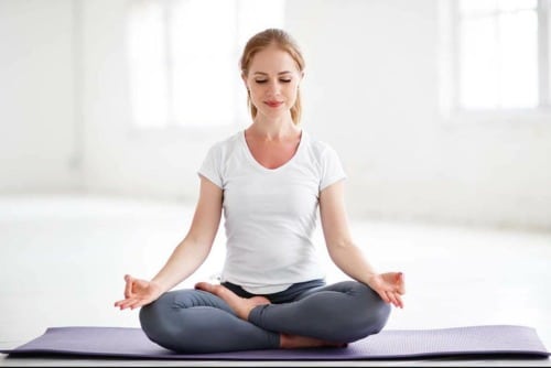 does yoga help with chronic pain woman in meditative pose wondering does yoga help with chronic pain