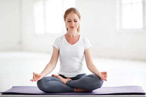 woman in meditative pose wondering does yoga help with chronic pain