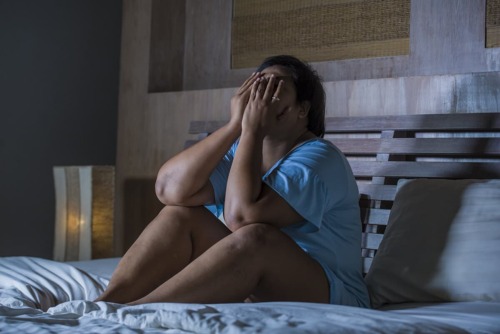 a young woman in bed suffering from drug withdrawal symptoms