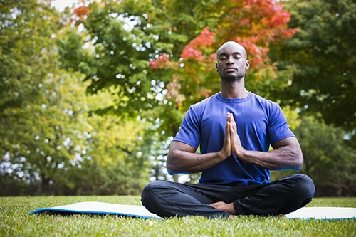 young man exercising yoga a man practicing holistic approach