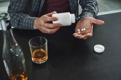man taking pills may be wondering is drug addiction a choice