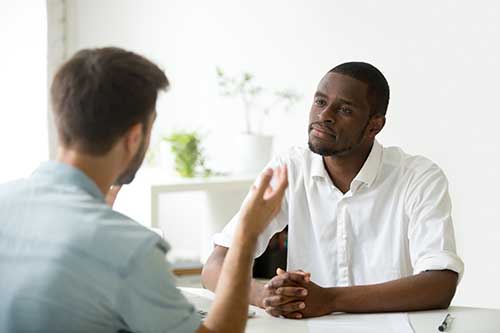 Two men talking at a men's drug rehab center