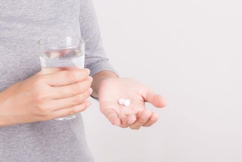 painkiller-addiction-signs a person looking at their medicing wondering if they show painkiller addiction signs