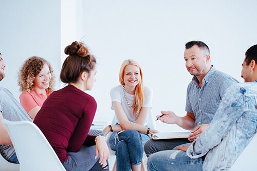 Man leading group session at a prescription drug addiction treatment center in Texas