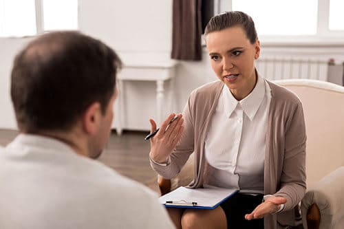 Counselor and client discussing how they will use psychodrama therapy during rehab