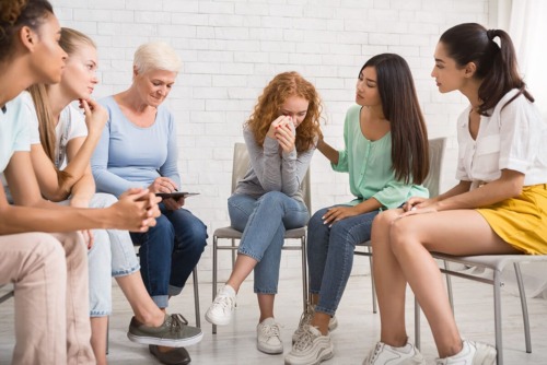 a group therapy session discussing their experiences at rehab center in Texas