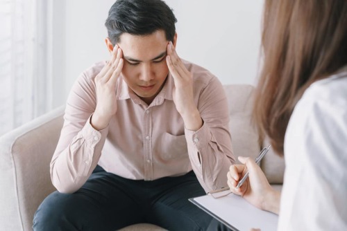 a man talking to a doctor about relapse triggers