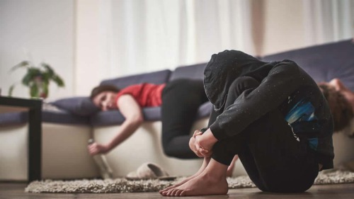 a girl passed out on a couch and a teen facing the risk factors for addiction