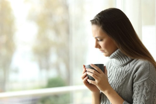 a woman praciticing stress management techniques while at work