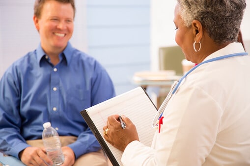 Man at our addiction rehab center in Texas talking to professional about our addiction treatment programs