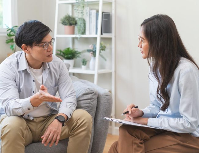male patient speaking to his female therapist about how meditation therapy is helping him