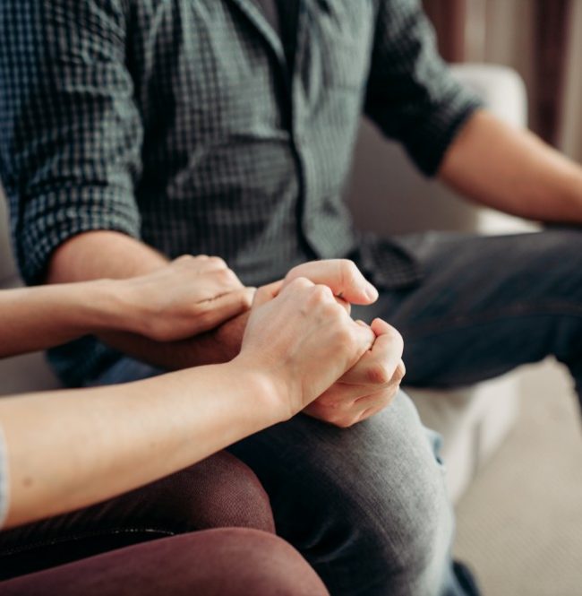 Couple hold hands at psychologist, family psychology support, civilized solution to the problem. Female doctor helps patients with consultation