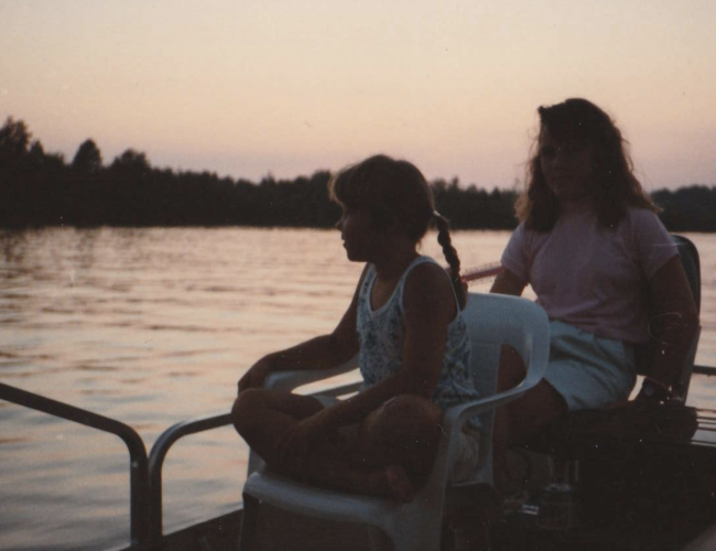 Mother and daughter on a boat on the lake