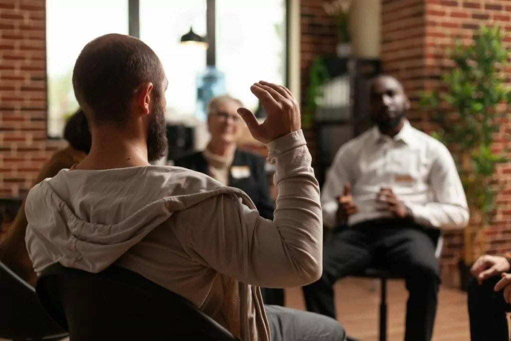 man speaking in group about Addiction Therapy Services in Houston