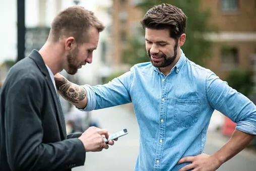 Man and man speaking outside of a AA meeting