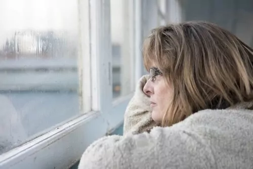 Woman, staring at the window thinking is a dictionary disease