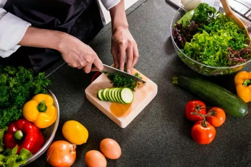 Woman cutting up vegetables for dinner