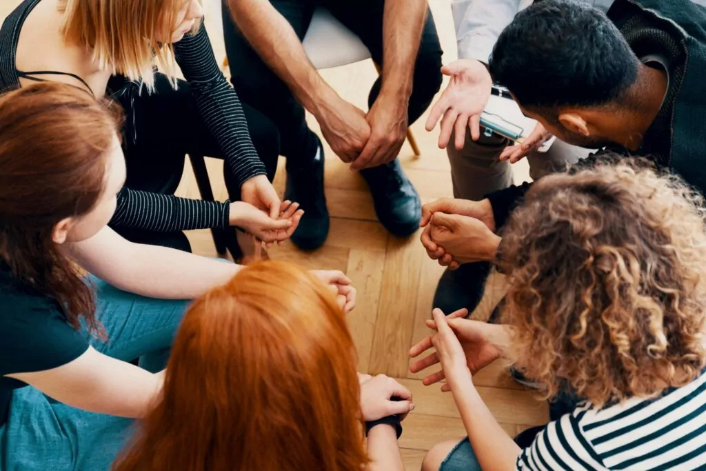 group of men and women sitting in a circle during group therapy in partial hospitalization program in houston