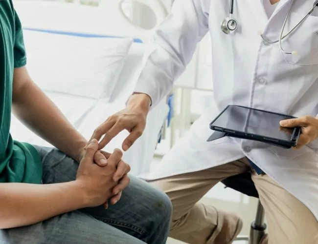 A man talking to a doctor at a Heroin Detox Center in Houston.