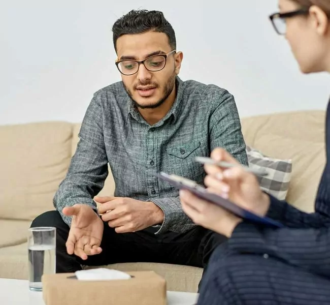 woman explaining to man what Cognitive Behavioral Therapy Addiction Treatment is
