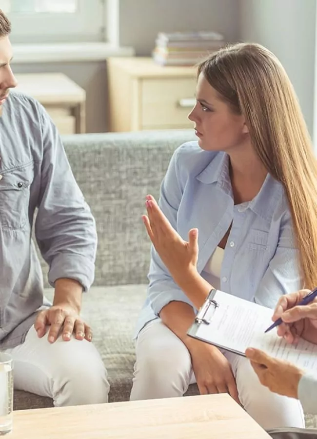 man and woman speaking with therapist during his stay at a mens alcohol rehab center in south houston