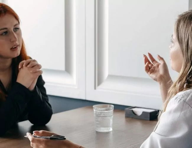Woman, speaking with her therapist on stimulant addiction