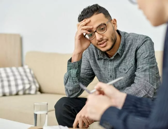man sitting in his alcohol detox therapy session