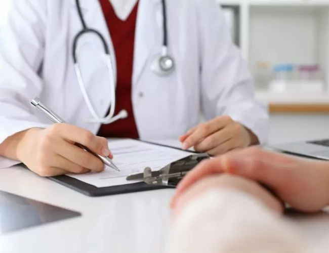 doctor at Houston detox center going over paperwork